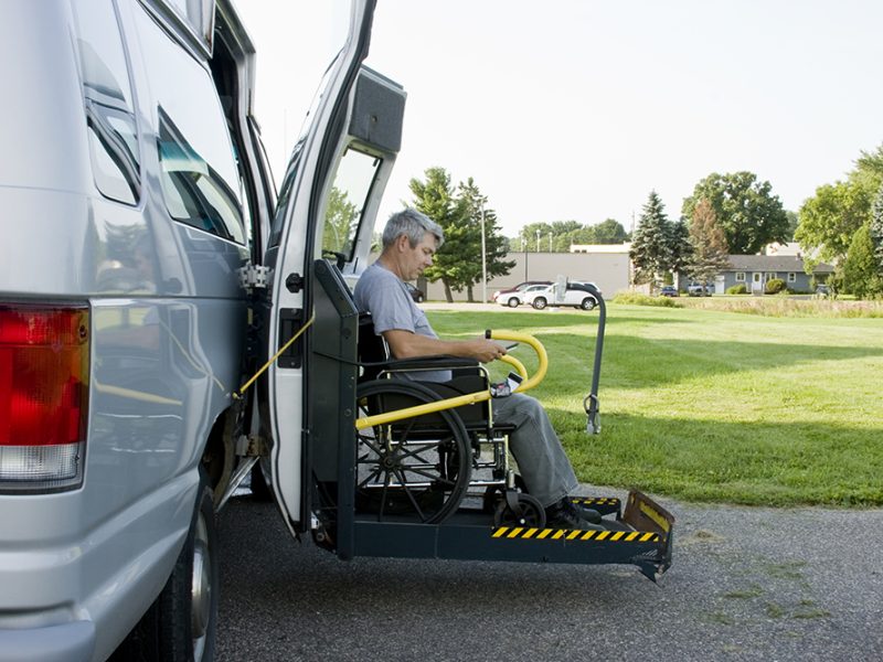 disability conversion lift van with a man in a wheelchair on the gate